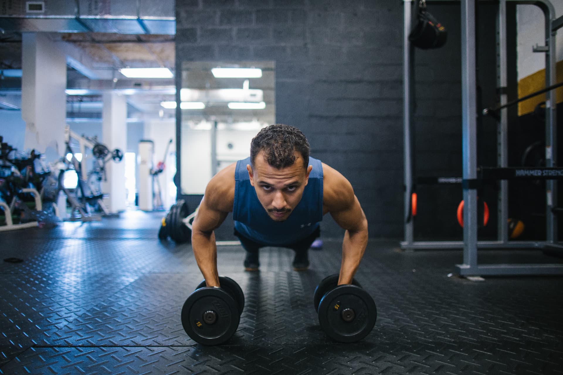 Breno demonstrating a dumbbell push-up
